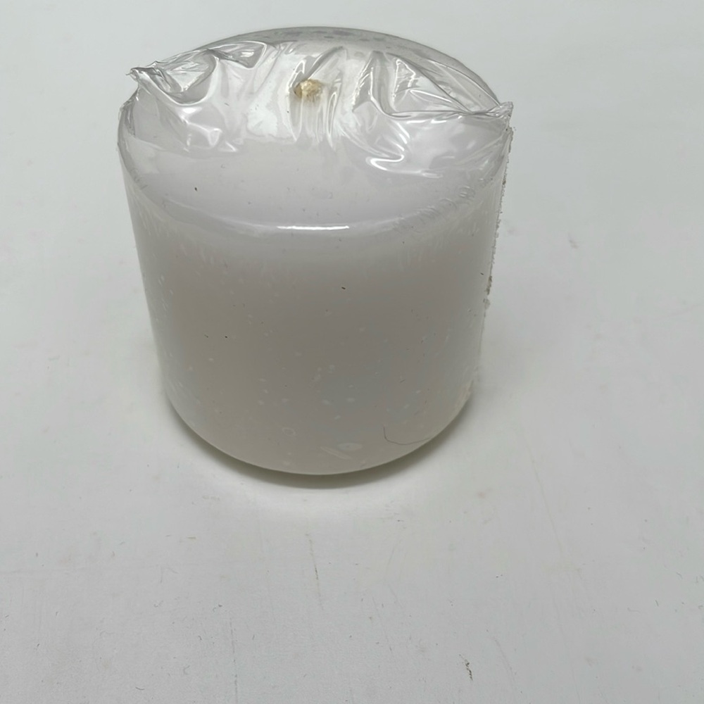 White Candle 2”across 3” tall new in protective wrapper.